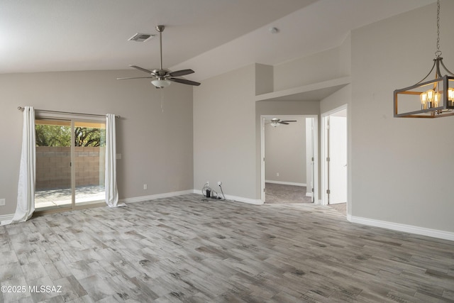 1542 N Amberbrooke Ave, Tucson, AZ 85745 - empty room with a ceiling fan, a chandelier, wood finished floors, baseboards, and high vaulted ceiling