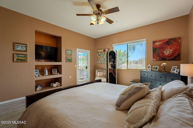 489 W Wedge Way, Green Valley, AZ 85614 - bedroom with wood finished floors, access to outside, baseboards, and a ceiling fan
