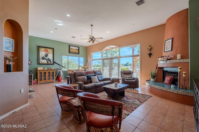 489 W Wedge Way, Green Valley, AZ 85614 - tiled living area featuring a ceiling fan, recessed lighting, baseboards, a fireplace with raised hearth, and arched walkways
