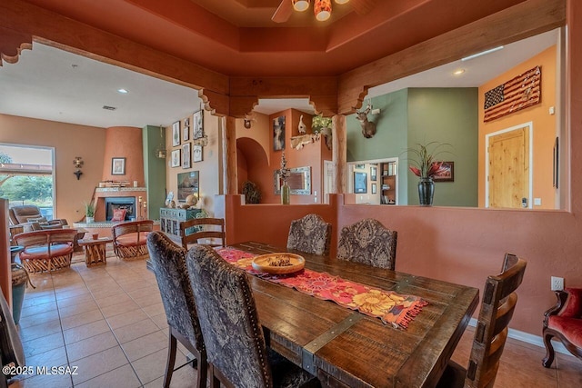 489 W Wedge Way, Green Valley, AZ 85614 - dining space with tile patterned flooring, ceiling fan, a fireplace, and recessed lighting