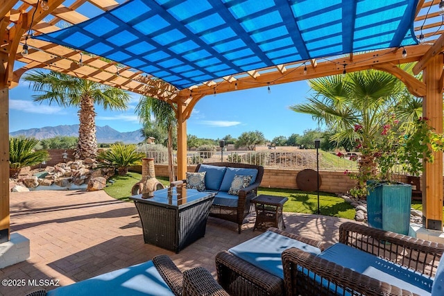 489 W Wedge Way, Green Valley, AZ 85614 - fenced backyard with a pergola, an outdoor hangout area, a mountain view, and a patio area