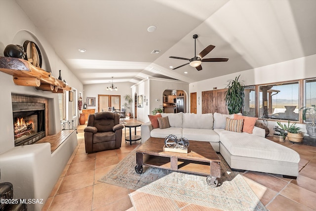 4 Mustang Trl, Sonoita, AZ 85637 - living area featuring lofted ceiling, a warm lit fireplace, a ceiling fan, a chandelier, and light tile patterned floors
