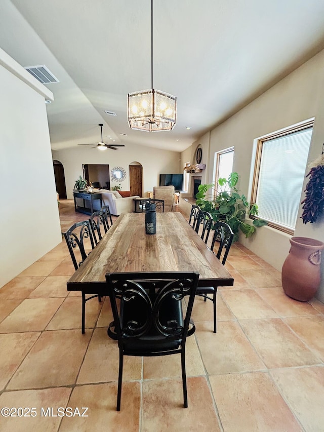 4 Mustang Trl, Sonoita, AZ 85637 - dining space featuring arched walkways, a ceiling fan, and a chandelier