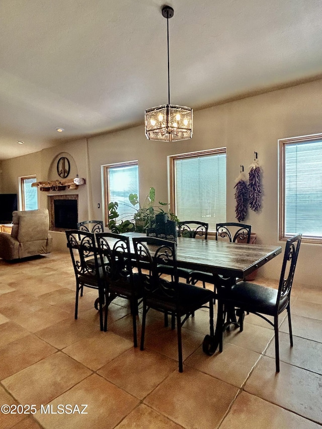4 Mustang Trl, Sonoita, AZ 85637 - dining room with light tile patterned flooring, a chandelier, and a fireplace