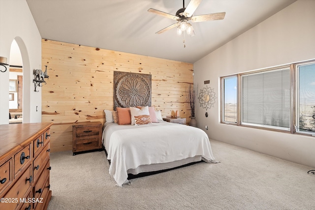 4 Mustang Trl, Sonoita, AZ 85637 - bedroom with arched walkways, light carpet, wooden walls, and a ceiling fan