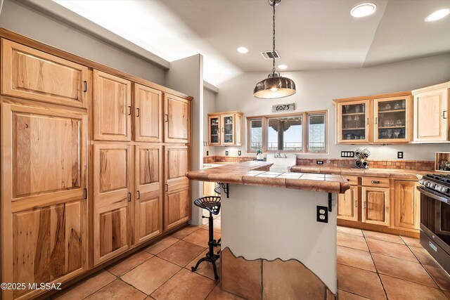 4 Mustang Trl, Sonoita, AZ 85637 - kitchen featuring gas range, a breakfast bar, light tile patterned flooring, recessed lighting, and a kitchen island