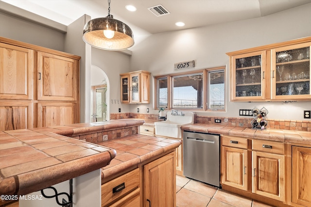 4 Mustang Trl, Sonoita, AZ 85637 - kitchen with stainless steel dishwasher, a sink, light tile patterned flooring, tile counters, and light brown cabinets