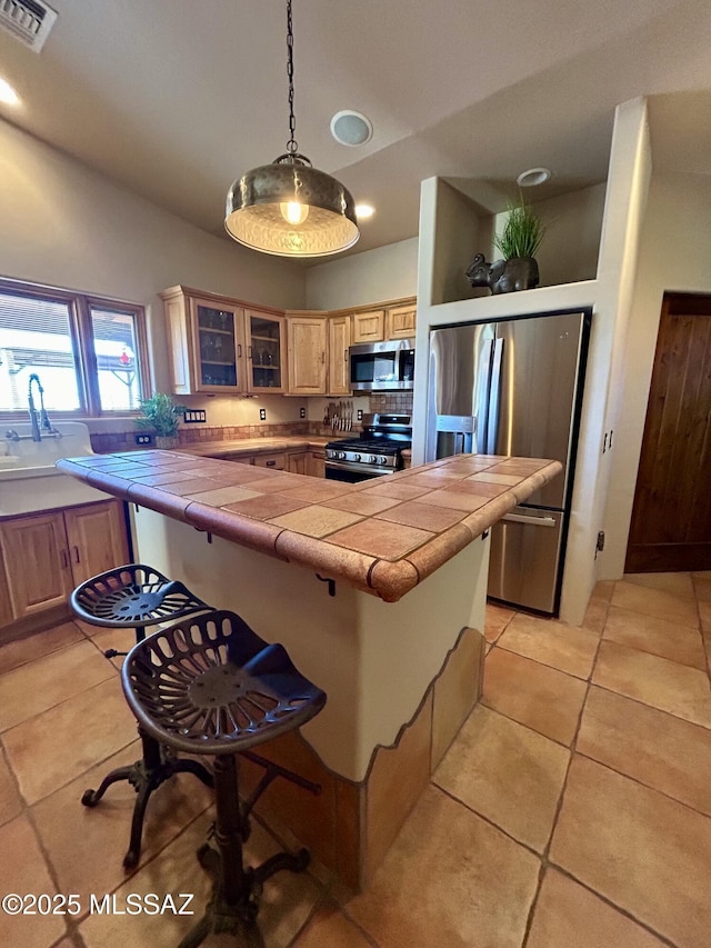 4 Mustang Trl, Sonoita, AZ 85637 - kitchen with stainless steel appliances, a kitchen bar, tile counters, glass insert cabinets, and recessed lighting