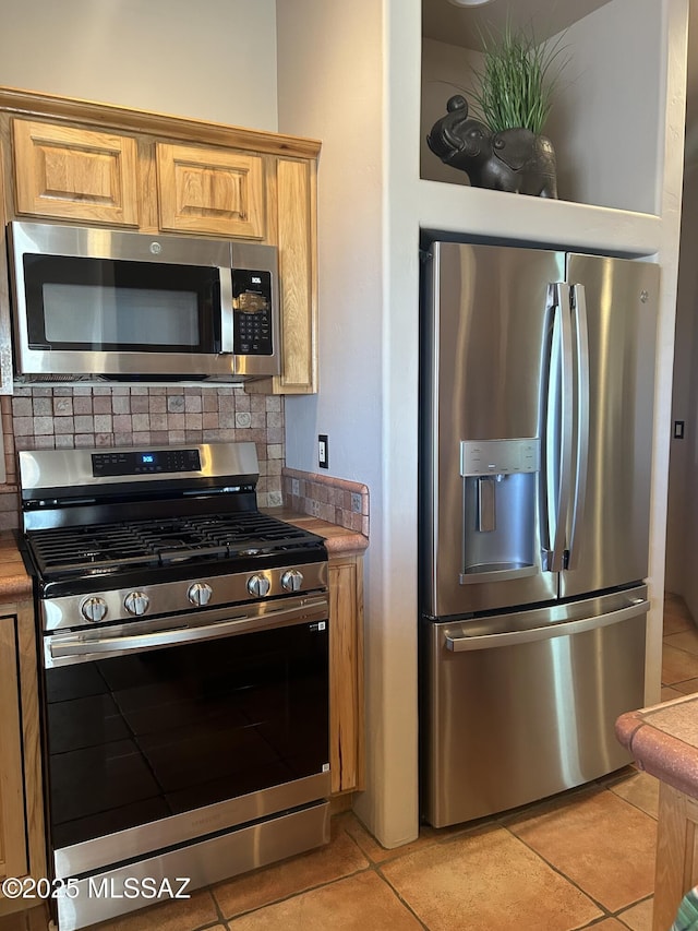 4 Mustang Trl, Sonoita, AZ 85637 - kitchen featuring appliances with stainless steel finishes, light tile patterned floors, and tasteful backsplash