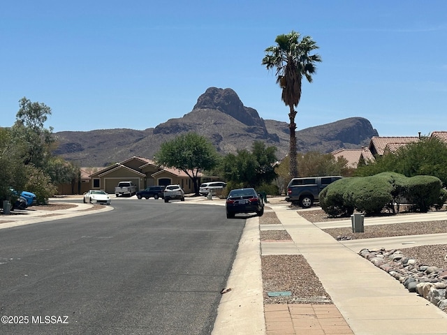 6960 W Harcuvar Dr, Tucson, AZ 85743 - view of asphalt street with a mountain view, sidewalks, and curbs