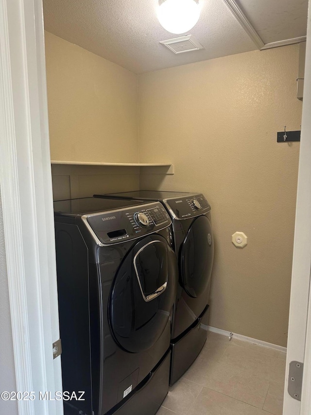 6960 W Harcuvar Dr, Tucson, AZ 85743 - washroom with washing machine and clothes dryer and baseboards