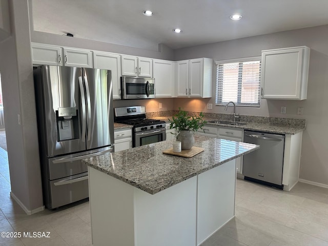 6960 W Harcuvar Dr, Tucson, AZ 85743 - kitchen with appliances with stainless steel finishes, a sink, light stone countertops, baseboards, and white cabinetry