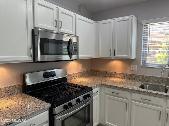 6960 W Harcuvar Dr, Tucson, AZ 85743 - kitchen featuring stainless steel appliances, a sink, white cabinetry, and light stone counters