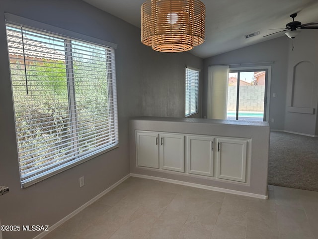 6960 W Harcuvar Dr, Tucson, AZ 85743 - unfurnished dining area with lofted ceiling, ceiling fan, baseboards, and a chandelier