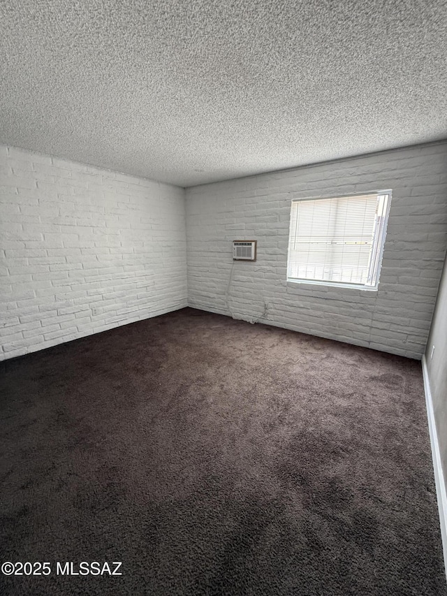 1036 W Michigan St, Tucson, AZ 85714 - spare room featuring carpet flooring, a textured ceiling, and a wall mounted air conditioner