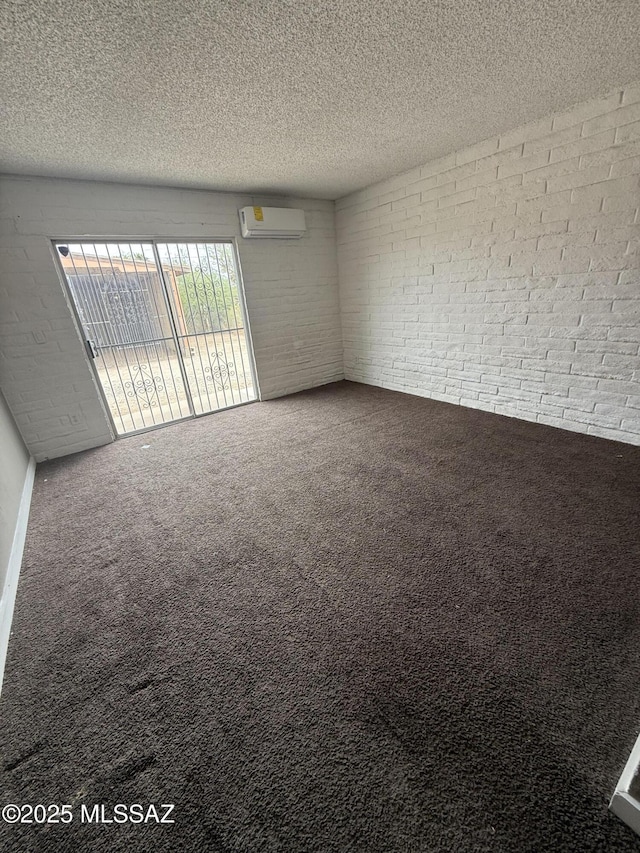 1036 W Michigan St, Tucson, AZ 85714 - unfurnished room featuring brick wall, a wall mounted AC, carpet flooring, and a textured ceiling