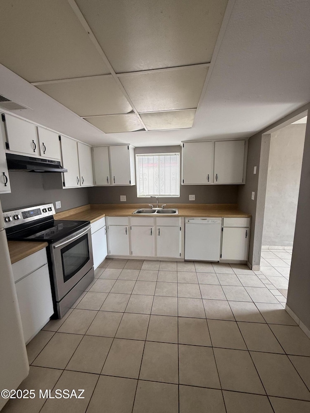 1036 W Michigan St, Tucson, AZ 85714 - kitchen with stainless steel electric range oven, white dishwasher, under cabinet range hood, a sink, and light tile patterned floors