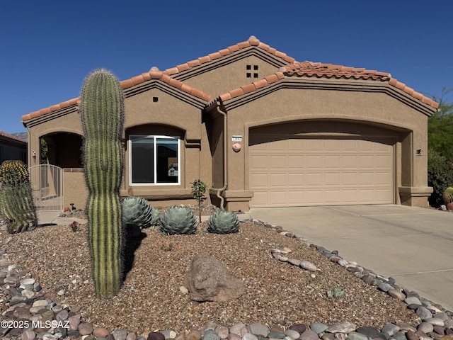 13942 N Cirrus Hill Dr, Oro Valley, AZ 85755 - mediterranean / spanish home with concrete driveway, a tiled roof, stucco siding, and a garage
