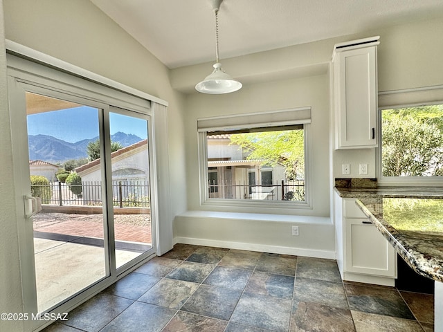 13942 N Cirrus Hill Dr, Oro Valley, AZ 85755 - unfurnished dining area with stone tile floors, plenty of natural light, and baseboards
