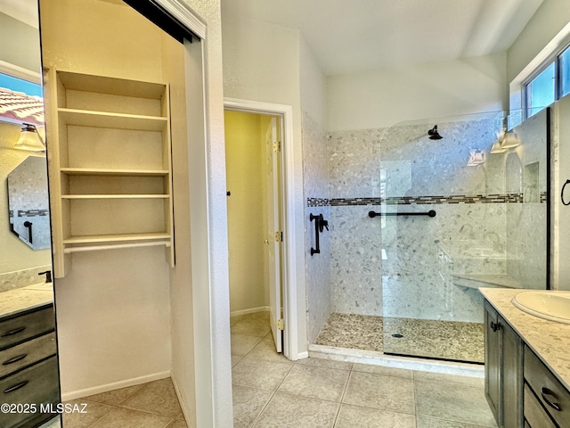 13942 N Cirrus Hill Dr, Oro Valley, AZ 85755 - bathroom featuring vanity, a walk in shower, tile patterned flooring, and a closet