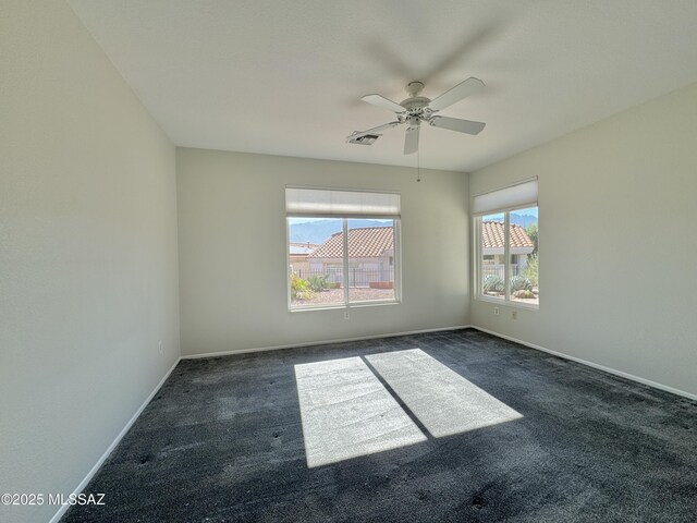 13942 N Cirrus Hill Dr, Oro Valley, AZ 85755 - empty room featuring dark carpet, plenty of natural light, and baseboards