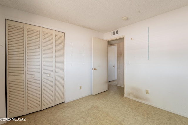 8401 E Shasta Dr, Tucson, AZ 85730 - unfurnished bedroom featuring tile patterned floors, a textured ceiling, a closet, and baseboards