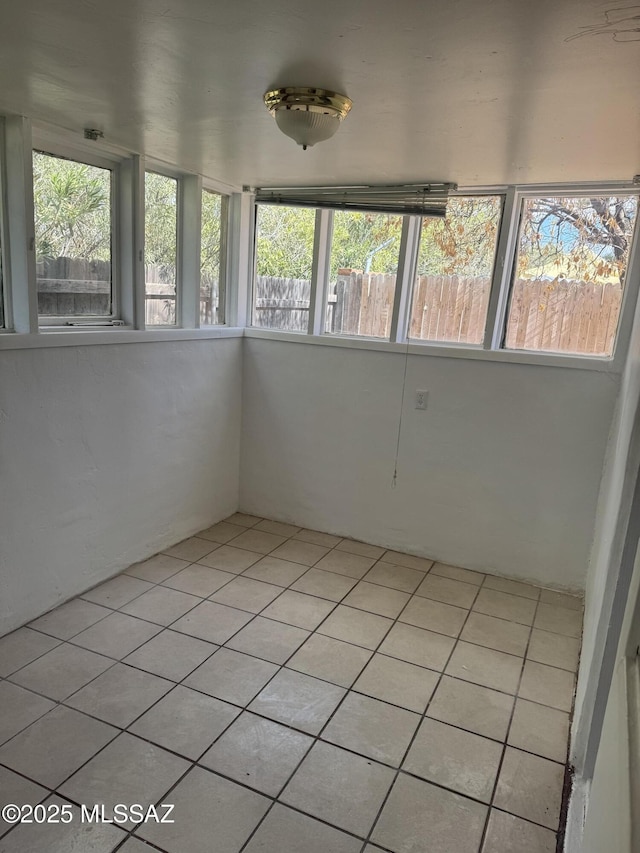 unfurnished sunroom with tile patterned floors