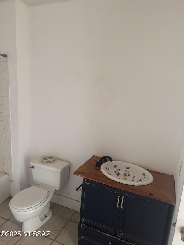 bathroom featuring tile patterned flooring, toilet, and vanity