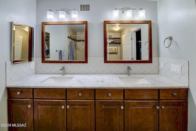 6631 N Camino Padre Isidoro, Tucson, AZ 85718 - full bathroom with tasteful backsplash, double vanity, and a tile shower