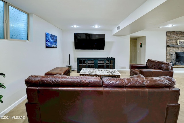 6631 N Camino Padre Isidoro, Tucson, AZ 85718 - living room with a stone fireplace, baseboards, and recessed lighting