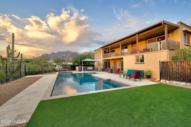 6631 N Camino Padre Isidoro, Tucson, AZ 85718 - pool at dusk with a patio area and a mountain view