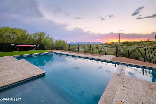 6631 N Camino Padre Isidoro, Tucson, AZ 85718 - pool at dusk featuring a patio area and a mountain view
