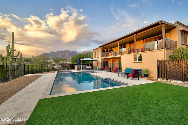 6631 N Camino Padre Isidoro, Tucson, AZ 85718 - pool at dusk with a patio area and a mountain view