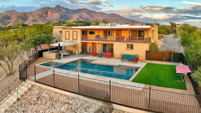 6631 N Camino Padre Isidoro, Tucson, AZ 85718 - rear view of house featuring a balcony, a mountain view, stucco siding, a chimney, and a patio area