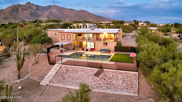 6631 N Camino Padre Isidoro, Tucson, AZ 85718 - back of property with a balcony, a fenced backyard, a mountain view, a patio area, and stucco siding