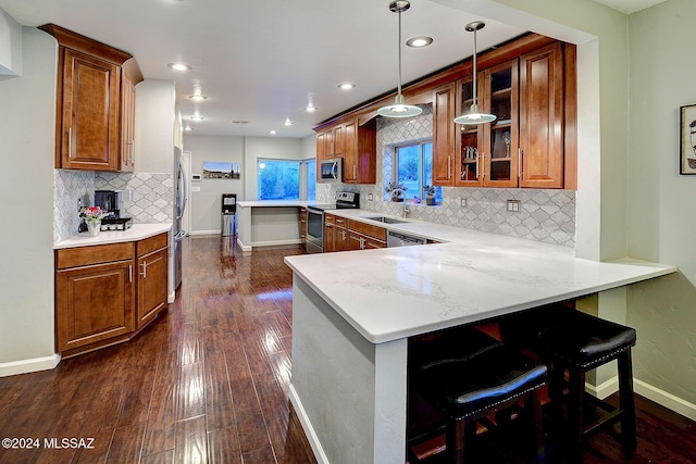 6631 N Camino Padre Isidoro, Tucson, AZ 85718 - kitchen featuring stainless steel appliances, brown cabinets, a peninsula, and recessed lighting