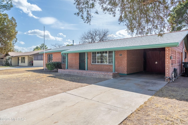 2702 E Prince Rd, Tucson, AZ 85716 - single story home featuring brick siding, concrete driveway, and a shingled roof