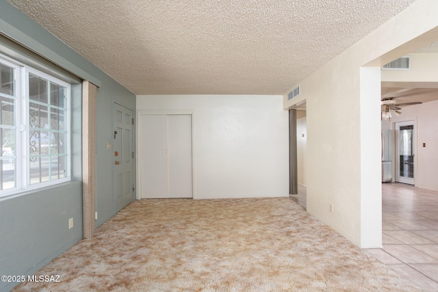 2702 E Prince Rd, Tucson, AZ 85716 - carpeted empty room featuring a ceiling fan and a textured ceiling