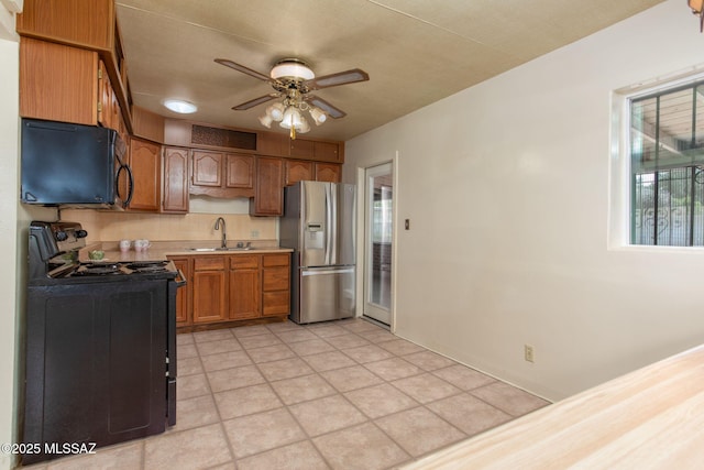 2702 E Prince Rd, Tucson, AZ 85716 - kitchen featuring black appliances, a ceiling fan, light countertops, a sink, and brown cabinets