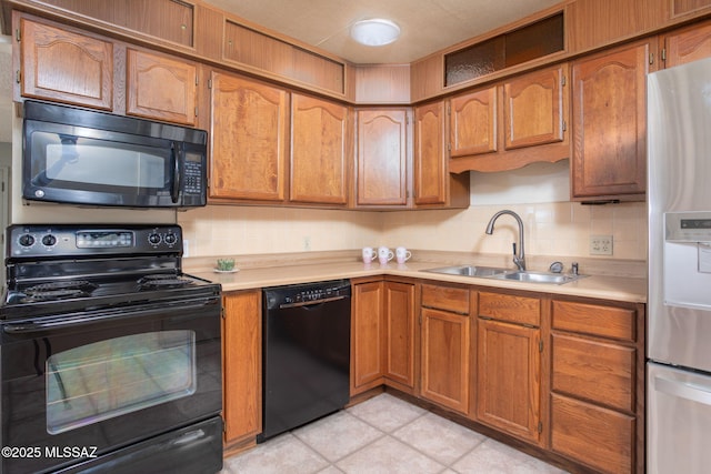 2702 E Prince Rd, Tucson, AZ 85716 - kitchen with black appliances, a sink, light countertops, and tasteful backsplash