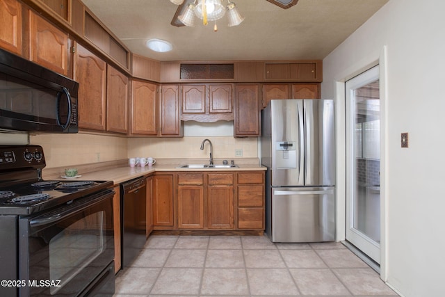 2702 E Prince Rd, Tucson, AZ 85716 - kitchen featuring black appliances, a sink, light countertops, decorative backsplash, and brown cabinetry