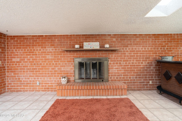 2702 E Prince Rd, Tucson, AZ 85716 - unfurnished living room featuring a fireplace, a textured ceiling, brick wall, and tile patterned floors