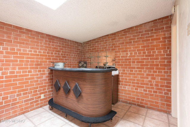 2702 E Prince Rd, Tucson, AZ 85716 - detailed view of brick wall, a textured ceiling, and bar