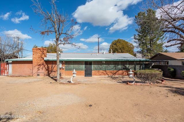 2702 E Prince Rd, Tucson, AZ 85716 - rear view of property featuring brick siding and a chimney