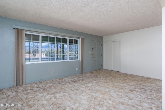 2702 E Prince Rd, Tucson, AZ 85716 - carpeted empty room featuring a textured ceiling