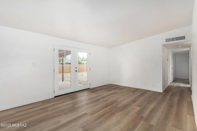 7433 E 19th St, Tucson, AZ 85710 - unfurnished room featuring french doors, wood finished floors, and baseboards