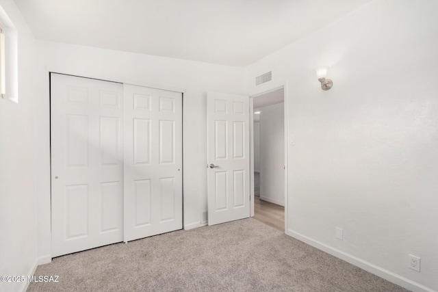 7433 E 19th St, Tucson, AZ 85710 - unfurnished bedroom with carpet, baseboards, and a closet
