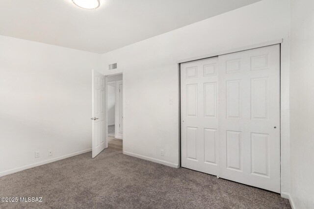 7433 E 19th St, Tucson, AZ 85710 - unfurnished bedroom featuring carpet, baseboards, and a closet