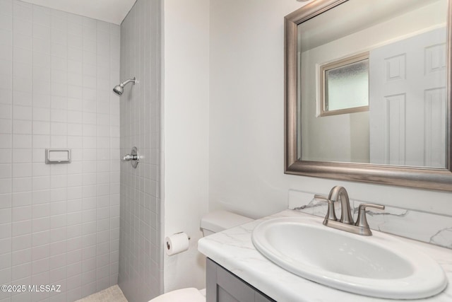 7433 E 19th St, Tucson, AZ 85710 - bathroom with tiled shower, vanity, and toilet