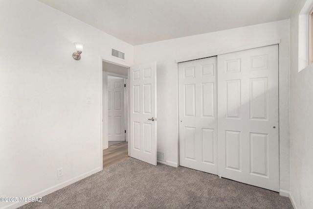 7433 E 19th St, Tucson, AZ 85710 - unfurnished bedroom featuring carpet flooring, baseboards, and a closet